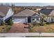 Single-story home with covered porch, paver driveway, and landscaped yard at 18879 Sailors Delight Pass, Land O Lakes, FL 34638