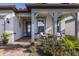 Covered front porch with seating area and landscaping at 18879 Sailors Delight Pass, Land O Lakes, FL 34638