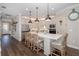 Modern kitchen with white cabinets, quartz countertops, and island seating at 18879 Sailors Delight Pass, Land O Lakes, FL 34638