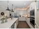 Spacious kitchen boasts an island, stainless steel appliances, and dark wood floors at 18879 Sailors Delight Pass, Land O Lakes, FL 34638