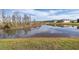 Scenic view of a tranquil lake with homes reflecting in the water at 18879 Sailors Delight Pass, Land O Lakes, FL 34638