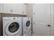 Laundry room with washer, dryer, and extra storage at 18879 Sailors Delight Pass, Land O Lakes, FL 34638