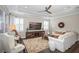 Relaxing living room with sectional sofa, TV, and large windows at 18879 Sailors Delight Pass, Land O Lakes, FL 34638