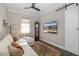 Spacious living room with a sofa, large TV, and barn door at 18879 Sailors Delight Pass, Land O Lakes, FL 34638