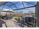 Enjoy lake views from this screened patio with a dining area and bar at 18879 Sailors Delight Pass, Land O Lakes, FL 34638