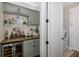 Convenient wet bar with wine cooler and shelving at 18879 Sailors Delight Pass, Land O Lakes, FL 34638