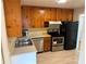 Kitchen with pine cabinets and stainless steel appliances at 201 W Seneca Ave, Tampa, FL 33612