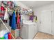 Laundry room with washer, dryer, and storage shelves at 4372 Odin St, Spring Hill, FL 34608