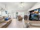 Bright living room with tile floors and a large TV at 4372 Odin St, Spring Hill, FL 34608