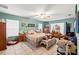 Main bedroom with a queen bed and large windows at 4372 Odin St, Spring Hill, FL 34608