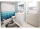 Clean bathroom with white vanity, shower/tub combo, and patterned curtain at 4649 Westerly Dr, New Port Richey, FL 34653