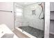 Modern bathroom with a walk-in shower and pebble floor at 4649 Westerly Dr, New Port Richey, FL 34653