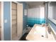 Bathroom with white vanity, blue walls, and teal shower curtain at 4649 Westerly Dr, New Port Richey, FL 34653