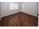 Bright bedroom featuring wood flooring and a large window at 4649 Westerly Dr, New Port Richey, FL 34653