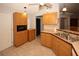 Kitchen boasts wood cabinets, tile flooring, and a double sink at 4649 Westerly Dr, New Port Richey, FL 34653