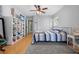 Serene bedroom with a queen bed, ceiling fan, and built-in shelving at 495 Druid Rd, Spring Hill, FL 34609