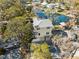 Aerial view showcasing a waterfront house and lush surroundings at 5287 Tuna Ln, Weeki Wachee, FL 34607