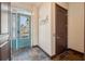 Inviting entryway with teal door and slate tile flooring at 5287 Tuna Ln, Weeki Wachee, FL 34607