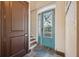 Bright entryway, teal door with glass panels, slate floor at 5287 Tuna Ln, Weeki Wachee, FL 34607