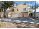 Two-story yellow house with balcony, garage, and well-maintained yard at 5287 Tuna Ln, Weeki Wachee, FL 34607
