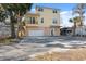 Two-story yellow house with balcony, garage, and spacious driveway at 5287 Tuna Ln, Weeki Wachee, FL 34607