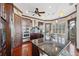Modern kitchen with dark wood cabinets, granite countertops, and stainless steel appliances at 5287 Tuna Ln, Weeki Wachee, FL 34607