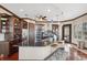 Modern kitchen with dark wood cabinets, granite countertops, and stainless steel appliances at 5287 Tuna Ln, Weeki Wachee, FL 34607