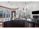 Modern kitchen with island, dark wood cabinets, and granite countertops at 5287 Tuna Ln, Weeki Wachee, FL 34607