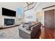 Living room with hardwood floors, fireplace, and TV at 5287 Tuna Ln, Weeki Wachee, FL 34607