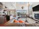 Spacious living room with high ceilings, fireplace, and large windows at 5287 Tuna Ln, Weeki Wachee, FL 34607