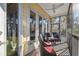 Covered screened porch with wicker furniture and ceiling fan at 5287 Tuna Ln, Weeki Wachee, FL 34607
