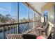 Screened porch overlooking the water with wicker seating at 5287 Tuna Ln, Weeki Wachee, FL 34607