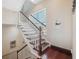 Elegant staircase with hardwood floors and white railings at 5287 Tuna Ln, Weeki Wachee, FL 34607