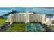 Aerial view of waterfront condo building with tennis courts and parking at 5915 Sea Ranch Dr # 501, Hudson, FL 34667