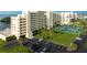 Aerial view of building, parking, and tennis courts at 5915 Sea Ranch Dr # 501, Hudson, FL 34667