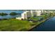 Aerial view of waterfront building, tennis courts, and parking at 5915 Sea Ranch Dr # 501, Hudson, FL 34667