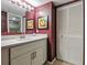 Bathroom features white vanity, marble countertop, and burgundy walls at 5915 Sea Ranch Dr # 501, Hudson, FL 34667