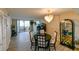Bright dining room with bay view, table, chairs, and display cabinet at 5915 Sea Ranch Dr # 501, Hudson, FL 34667