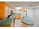 Well-equipped kitchen with light wood cabinets and teal countertops at 5915 Sea Ranch Dr # 501, Hudson, FL 34667