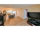 Living room features hardwood floors and a large TV at 5915 Sea Ranch Dr # 501, Hudson, FL 34667