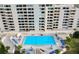 Community pool with surrounding lounge chairs at 5915 Sea Ranch Dr # 501, Hudson, FL 34667