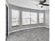 Bright bedroom with large windows and grey carpeting at 5925 Seaside Dr, New Port Richey, FL 34652