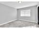 Well-lit bedroom with window blinds and grey carpet at 5925 Seaside Dr, New Port Richey, FL 34652