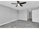 Spacious bedroom with ceiling fan and grey walls at 5925 Seaside Dr, New Port Richey, FL 34652