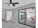 Bedroom with private balcony access and ceiling fan at 5925 Seaside Dr, New Port Richey, FL 34652