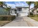 Two-story house with white exterior, attached garage, and landscaping at 5925 Seaside Dr, New Port Richey, FL 34652