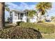 White house with landscaping, palm trees, and a two-car garage at 5925 Seaside Dr, New Port Richey, FL 34652