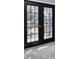 Black French doors leading to a balcony with wrought iron railings at 5925 Seaside Dr, New Port Richey, FL 34652