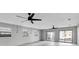 Spacious living area with ceiling fans and sliding glass doors opening to backyard at 5925 Seaside Dr, New Port Richey, FL 34652