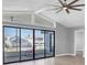Living room with sliding doors opening to a peaceful patio view at 5925 Seaside Dr, New Port Richey, FL 34652